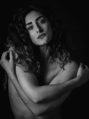 Emotive fine art portrait in black and white showing a woman’s quiet strength, subtle emotion, and powerful presence in soft grayscale