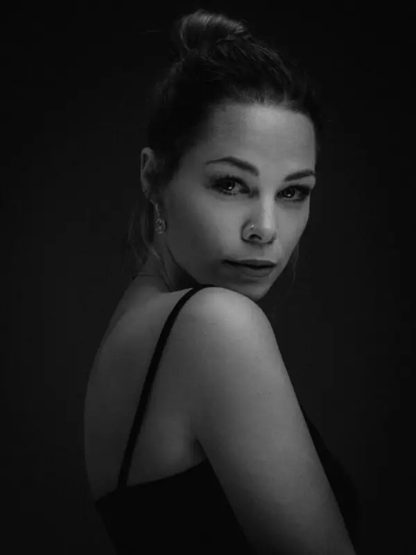 Bold black and white fine art portrait of a woman in solitude, capturing emotional depth, stillness, and quiet strength