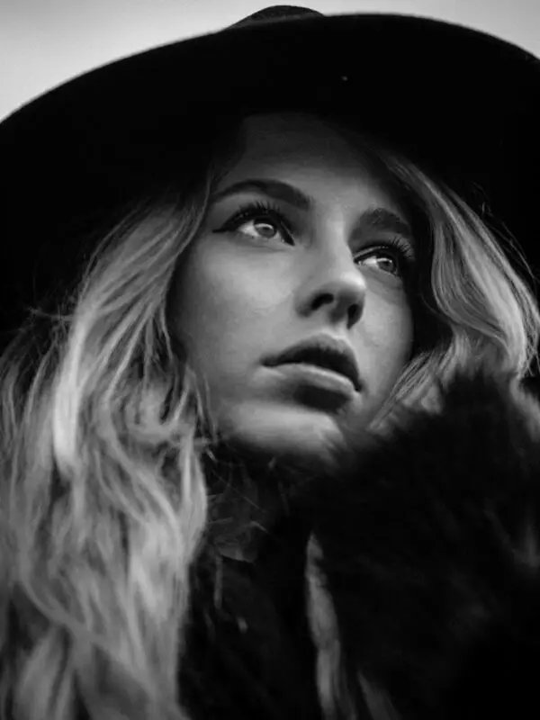Velvet monochrome fine art portrait of a woman in grayscale, radiating quiet power, poetic presence, and soft emotional stillness