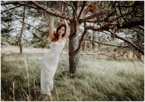 Anna in the forest, wearing a lucent dress